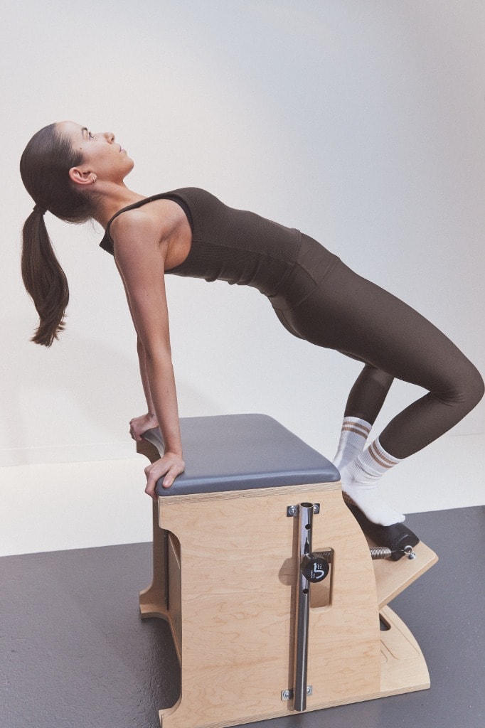 A client practicing extension and spinal support on the Wunda Chair